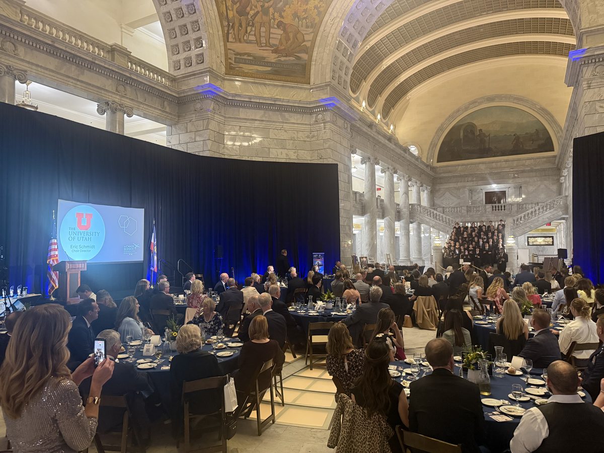 Gala with stage, screen, and round tables inside the Utah State Capitol rotunda