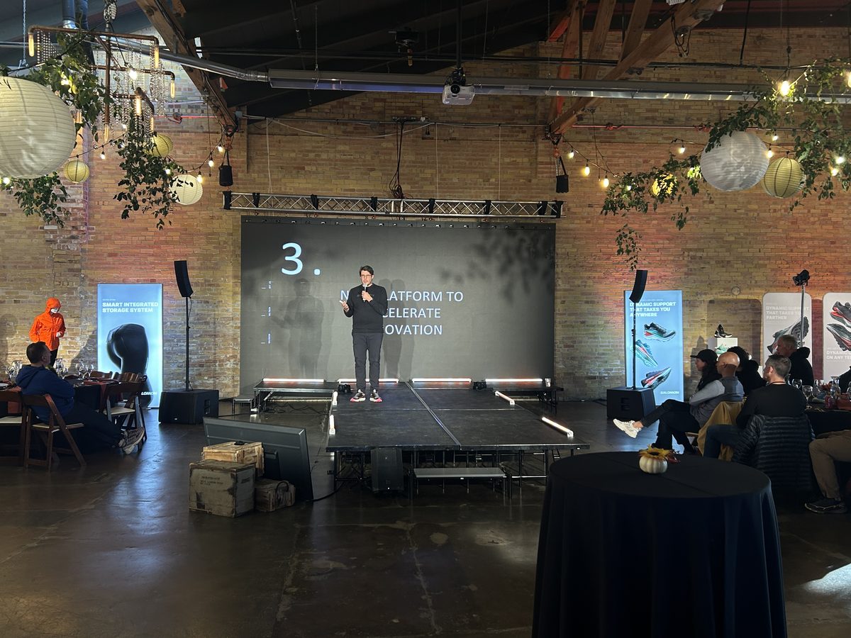 Presenter on stage with a projection screen and a downstage confidence monitor