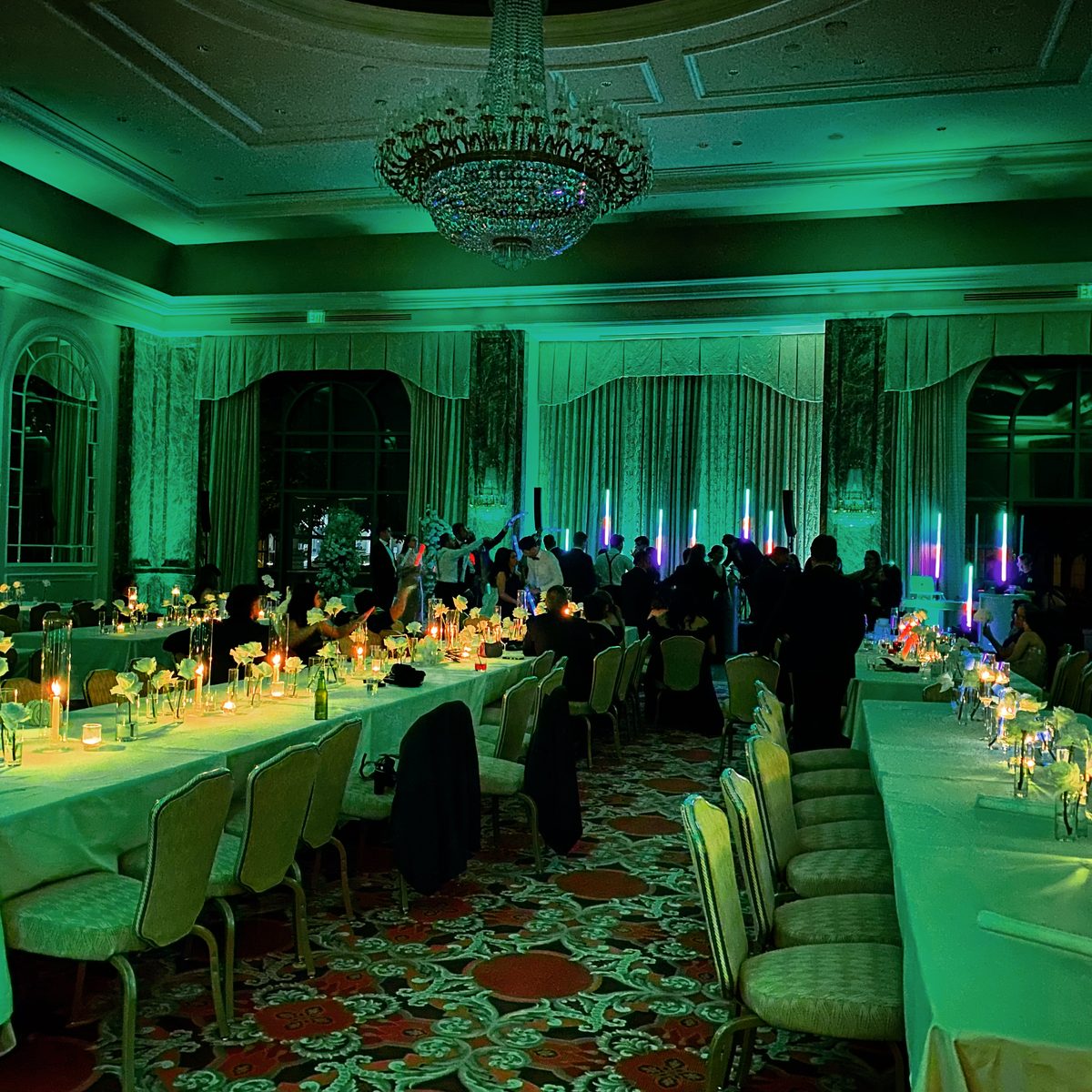 Grand America ballroom transformed with green uplighting for a corporate event